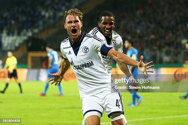 Benedikt Hoewedes of Schalke celebrates his team's second goal with team mate Jefferson Farfan of Schalke during the DFB Cup second round match...