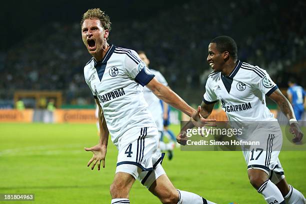 Benedikt Hoewedes of Schalke celebrates his team's second goal with team mate Jefferson Farfan of Schalke during the DFB Cup second round match...