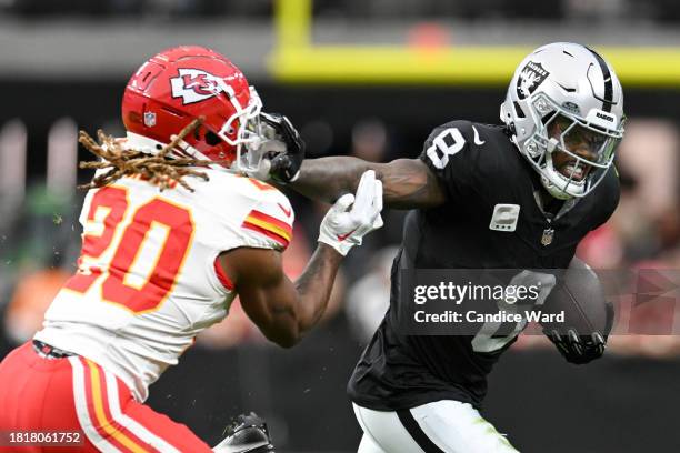 Running back Josh Jacobs of the Las Vegas Raiders runs the ball past safety Justin Reid of the Kansas City Chiefs in the first quarter at Allegiant...