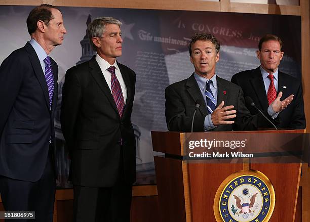 Sen. Rand Paul speaks while U.S. Sen. Ron Wyden , U.S. Sen. Mark Udall and U.S. Sen. Richard Blumenthal , listen during a news conference on Capitol...