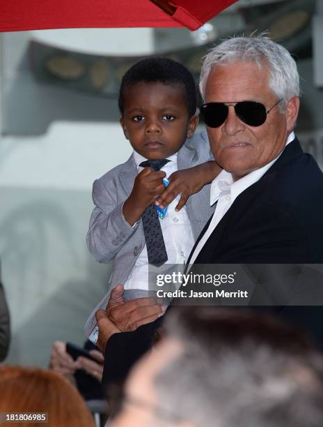 Actress Sandra Bullock's son Louis looks on as actress Sandra Bullock is immortalized with a hand and footprint ceremony at TCL Chinese Theatre on...