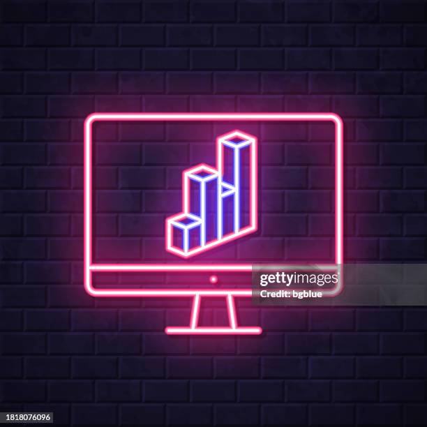 desktop computer with 3d chart. glowing neon icon on brick wall background - isometric computer desk stock illustrations