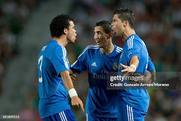 Cristiano Ronaldo of Real Madrid CF celebrates scoring their opening goal with teammates Pepe and Angel Di Maria during the La Liga match between...