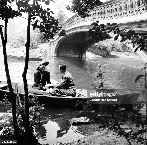 View of a well-dressed couple as they enjoy boating on one of the ponds in Central Park, New York, New York, 1948.