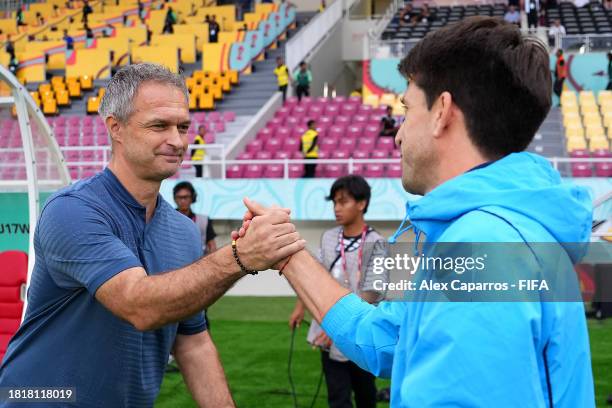 Diego Placente, Manager of Argentina and Christian Wueck, Manager of Germany shake hands during the FIFA U-17 World Cup Semi Final match between...