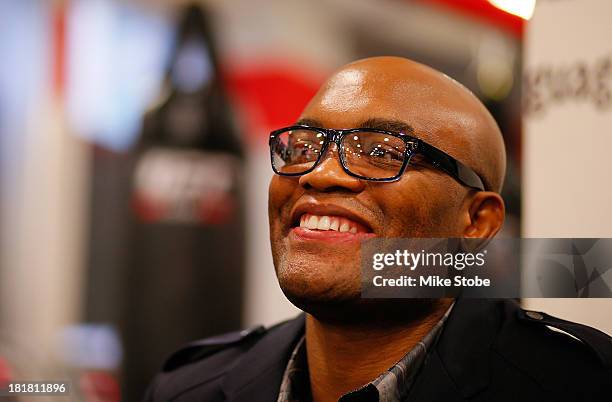 Mixed martial artist Anderson Silva of Brazil signs autographs for fans during a UFC autograph signing at UFC Gym on September 25, 2013 in New York...