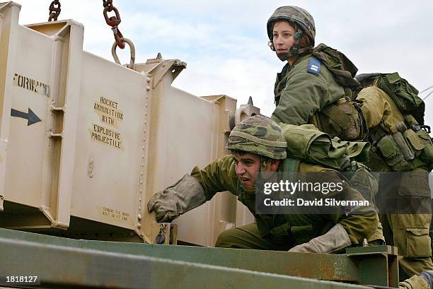 Israeli soldiers load a Patriot anti-aircraft and anti-ballistic missile missile onto a launcher February 27, 2003 at the Hafetz Hayim army base near...