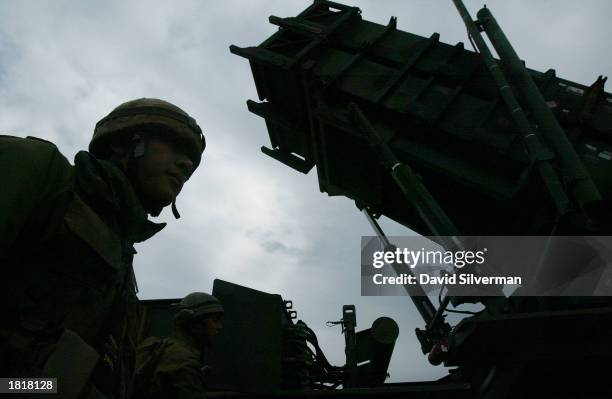 An Israeli soldier stands alongside a Patriot missile launcher as the anti-aircraft and anti-ballistic missile missile is ready to launch February...