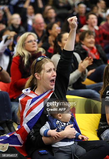 Fan reacts while watching the America's Cup at a venue set up in downtown Auckland with large television screens on September 26, 2013. Despondent...