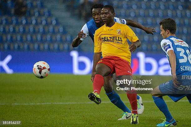 Herve Onana of AFC Tubize - Bennard Kumordzi of Krc Genk in action during the Cofidis Cup match between KRC Genk and AFC Tubize on September 25, 2013...