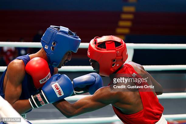 Carlos Santos of Brazil fights with Jose Zarraga of Venezuela during the Men's 49kg Boxing Finals as part of the I ODESUR South American Youth Games...