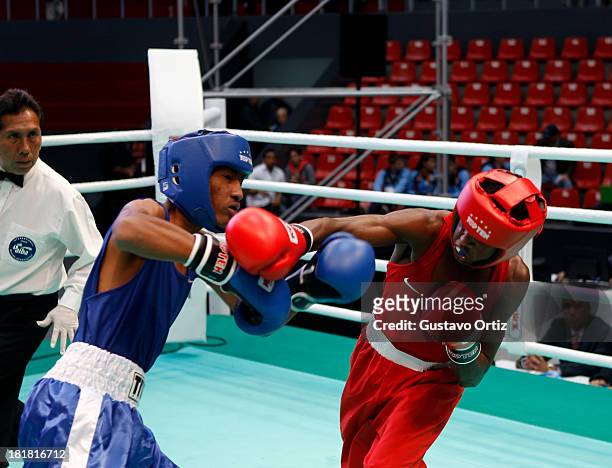 Carlos Santos of Brazil fights with Jose Zarraga of Venezuela during the Men's 49kg Boxing Finals as part of the I ODESUR South American Youth Games...