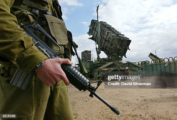 An Israeli soldier stands alongside a Patriot missile launcher as the anti-aircraft and anti-ballistic missile missile is made ready to launch...