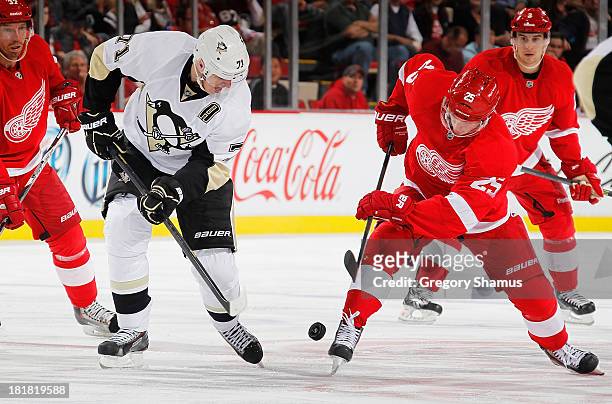 Cory Emmerton of the Detroit Red Wings battles for the puck with Evgeni Malkin of the Pittsburgh Penguins in the second period during a pre season...