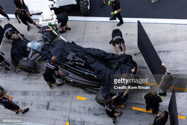 The damaged Mercedes of George Russell is returned to pitlane during Formula 1 testing at Yas Marina Circuit on November 28, 2023 in Abu Dhabi,...