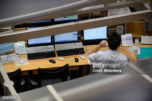 An employee works on the trading floor of the Tokyo Commodity Exchange Inc. In Tokyo, Japan, on Wednesday, Sept. 25, 2013. Tokyo Commodity Exchange,...