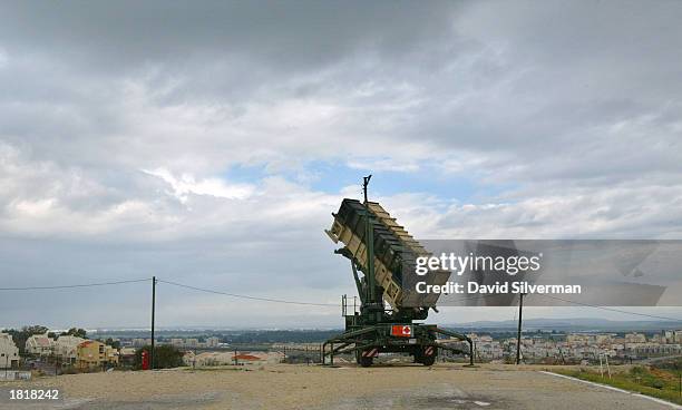 Patriot missile launcher towers over the Israeli town of Gadera February 27, 2003 from the Hafetz Hayim army base. The Israeli army demonstrated the...