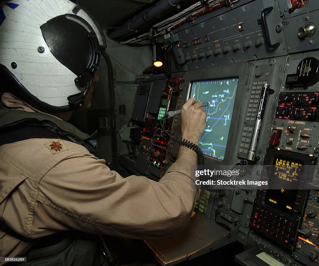 A Naval Flight Officer tracks aircraft at his station on an E-2C Hawkeye.