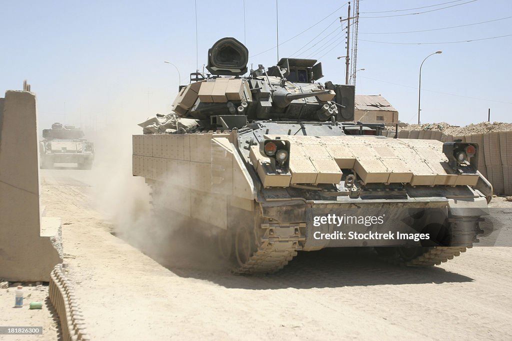 June 6, 2006 - U.S. Soldiers in an M2 Bradley Fighting Vehicle patrol past Command Post Hit, near Hit, Iraq.