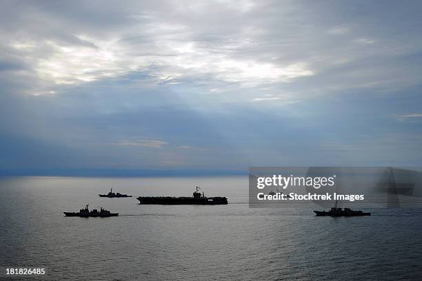 a fleet of multinational navy ships transit the korea strait. - cruzador navio de guerra - fotografias e filmes do acervo