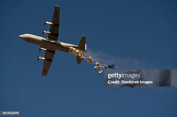 a u. s. air force c-130 hercules airdrops 20 bundles over afghanistan. - military crate stock pictures, royalty-free photos & images