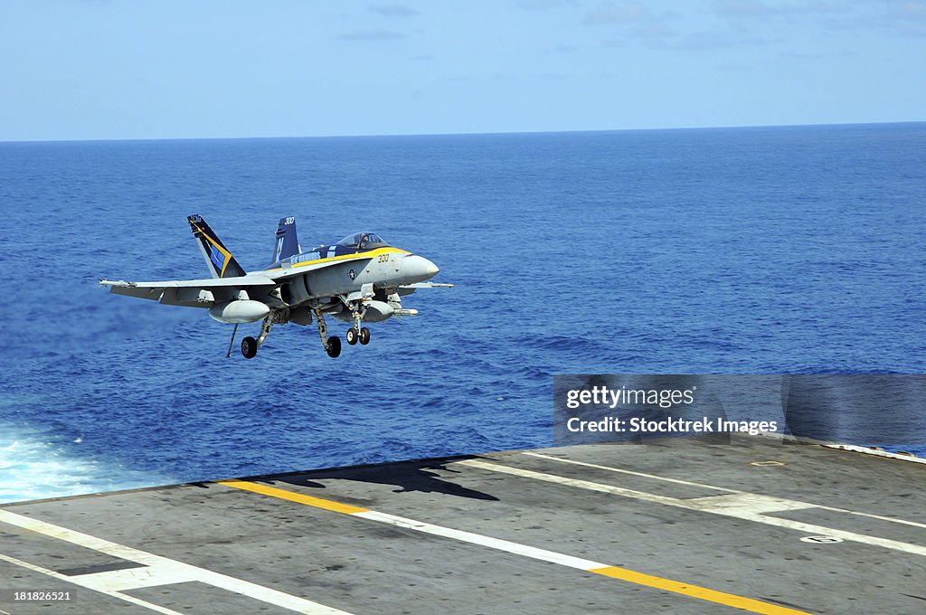 Pacific Ocean, October 20, 2011 - An F/A-18C Hornet lands aboard the aircraft carrier USS Ronald Reagan.