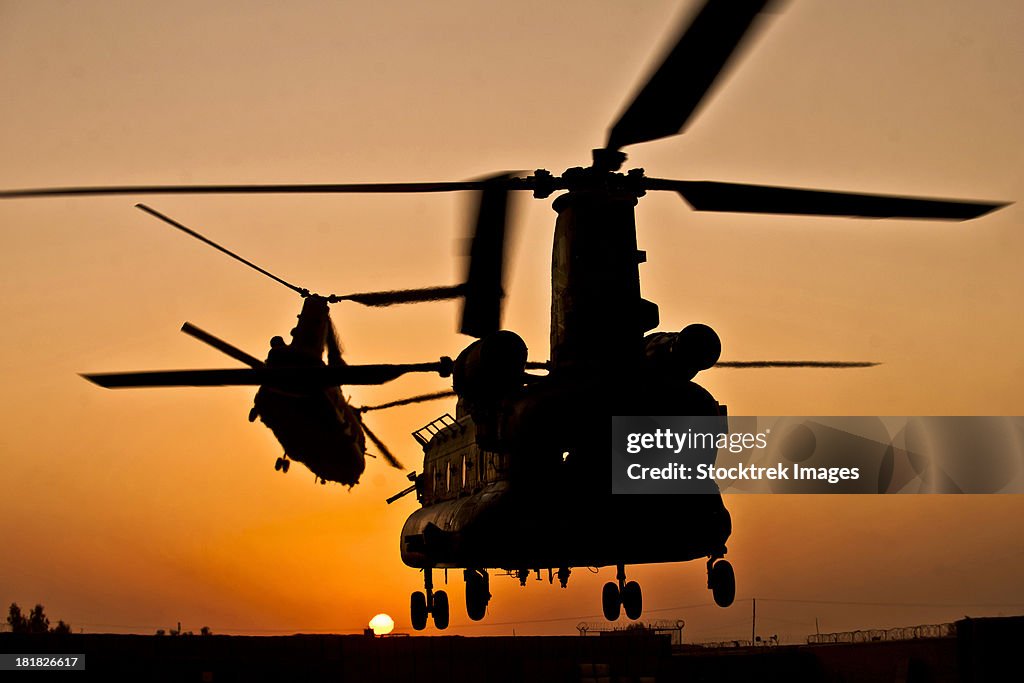 Two Royal Air Force CH-47 Chinooks take off from Task Force Helmand headquarters in Lashkar Gah district, Helmand province, Afghanistan.