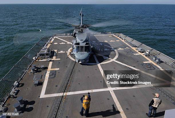 an sh-60b sea hawk lands on the flight deck of uss forrest sherman. - destroyer stock pictures, royalty-free photos & images