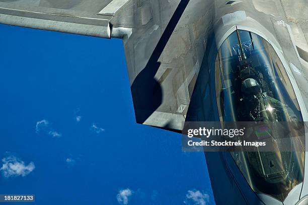 march 27, 2012 - an f-22 raptor in flight during a refueling mission over the hawaiian islands.  - f 22 raptor stock pictures, royalty-free photos & images