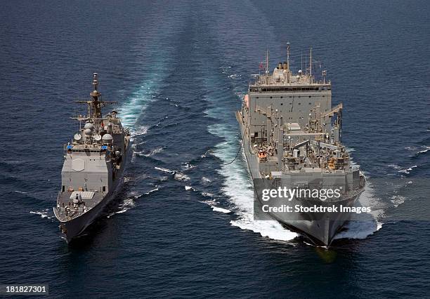 uss cape st. george pulls alongside usns charles drew for a replenishment at sea. - arabian sea stock pictures, royalty-free photos & images