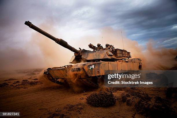 marines roll down a dirt road on their m1a1 abrams main battle tank during a day of training at exercise africa lion 2012. - tank fotografías e imágenes de stock