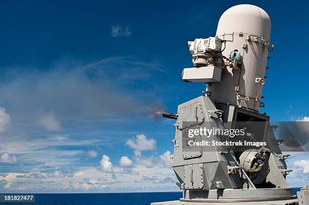 a phalanx close-in weapons system is fired aboard uss cowpens. - phalanx stock pictures, royalty-free photos & images