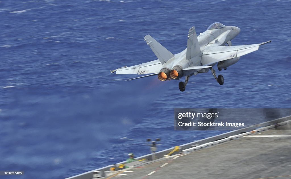 Pacific Ocean, June 27, 2012 - An F/A-18C Hornet launches from the flight deck of the aircraft carrier USS Nimitz.