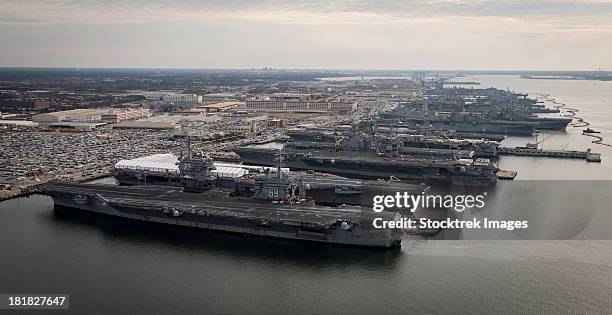 aircraft carriers in port at naval station norfolk, virginia. - marinebasis stockfoto's en -beelden