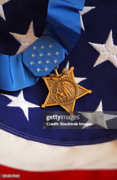 the medal of honor rests on a flag during preparations for an award ceremony. - courage award stock pictures, royalty-free photos & images