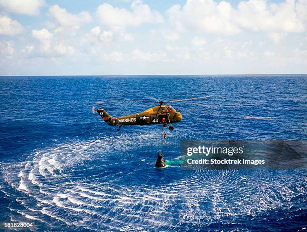 may 5, 1961 - an astronaut is rescued by a u.s. marine helicopter at the termination of his suborbital flight down range from the florida eastern coast.  - 1961 stock pictures, royalty-free photos & images