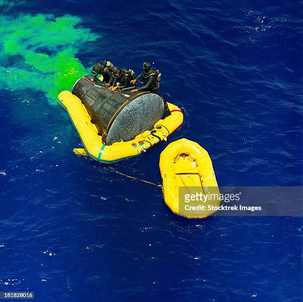 june 7, 1965 - a united states navy frogman team participates in the recovery of the gemini-titan 4 spacecraft. the uss wasp was the prime recovery ship for the gemini-4 mission.  - splashdown stock pictures, royalty-free photos & images