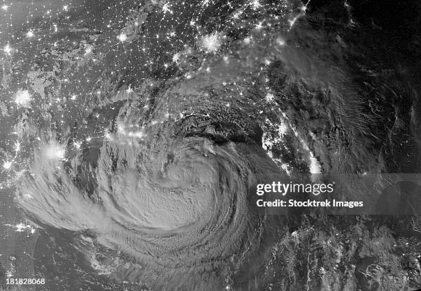 august 28, 2012 - nighttime view of tropical storm isaac and the cities near the gulf coast of the united states.   - tempesta tropicale isaac foto e immagini stock