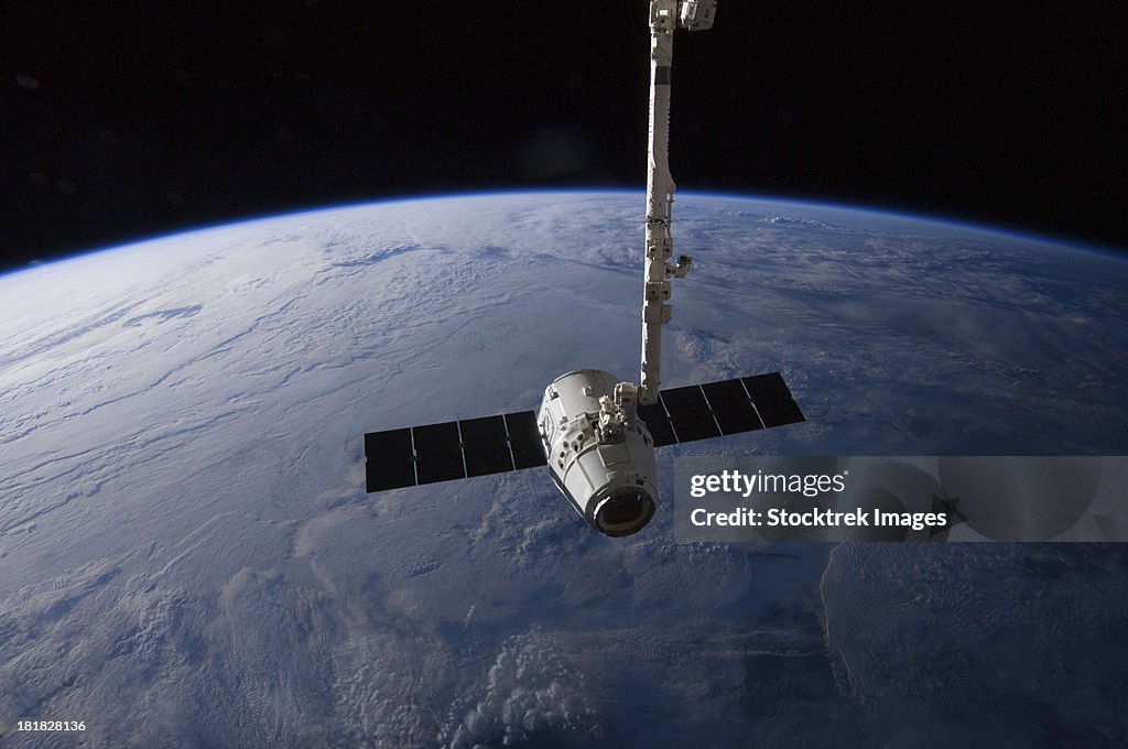 May 31, 2012 - The SpaceX Dragon cargo craft is suspended in the grasp of the Candarm2 robotic arm some 240 miles above Earth.