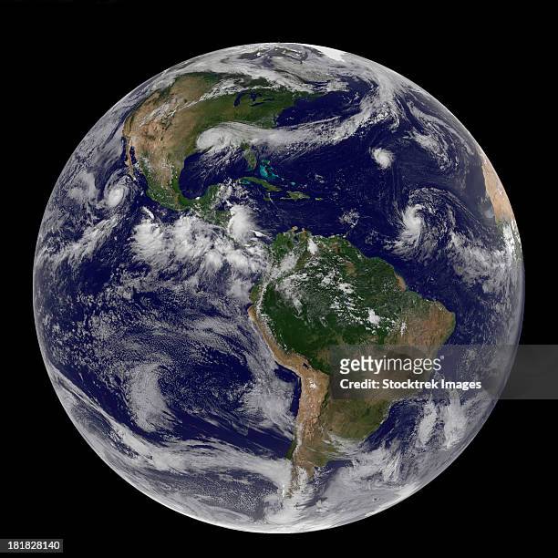 satellite image of earth and three tropical cyclones. - tropical storm isaac foto e immagini stock