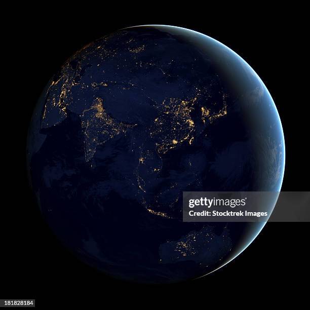 full earth at night showing city lights of asia and australia. - australia from space stock-fotos und bilder