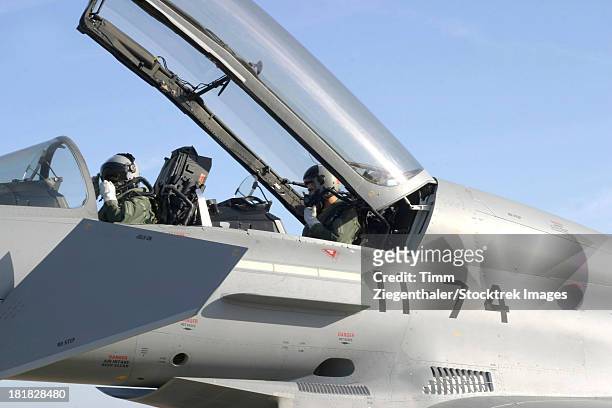 pilots perform preflight checks in the cockpit of a spanish air force eurofighter typhoon, moron, spain. - eurofighter typhoon stock pictures, royalty-free photos & images