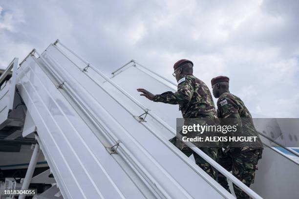 Kenyan soldiers from the East African Community regional force board a plane to leave the Democratic Republic of Congo, at Goma airport, on December...