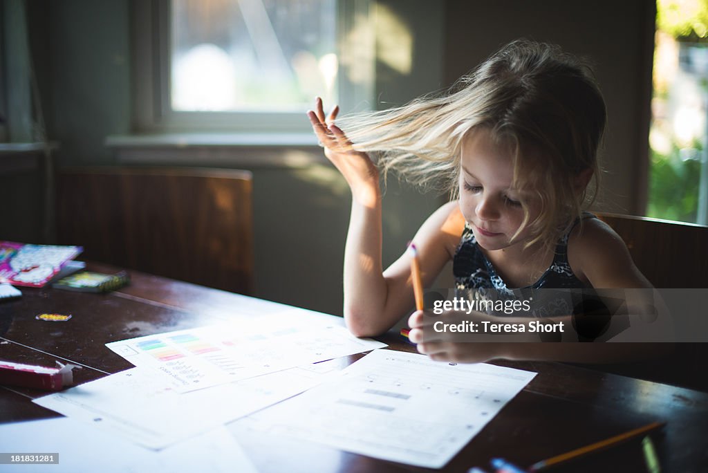 Girl with Pencil doing Homework