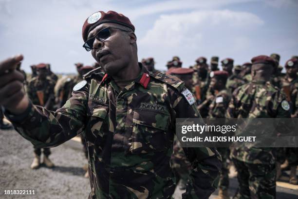 An Kenyan officer from the from the East African Community regional force gestures as Kenyan soldiers prepare to leave the Democratic Republic of...