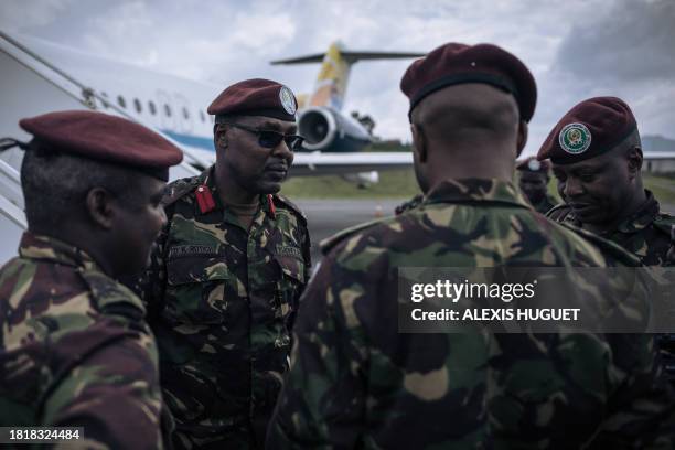 Kenyan military officers from the East African Community regional force stand on the airstrip before leaving the Democratic Republic of Congo, at...