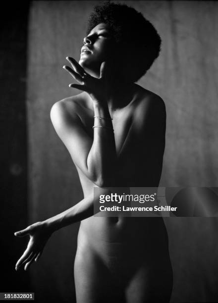 Studio portrait of American dancer and actress Paula Kelly as she poses naked, 1969.