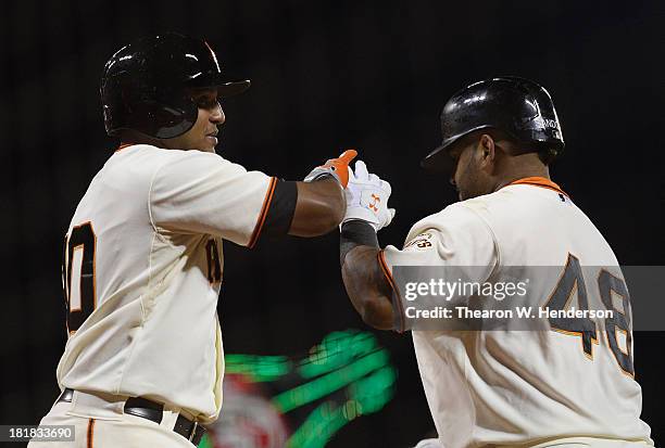 Pablo Sandoval of the San Francisco Giants is congratulated by Tony Abreu after Sandoval hit a two-run homer during the fourth inning against the Los...