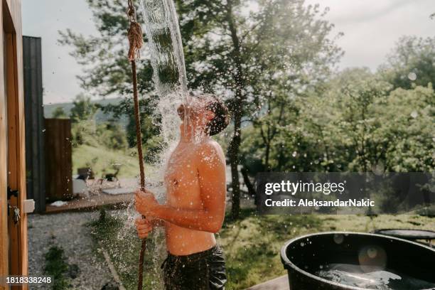 an ice cold bucket after a steamy sauna - cryotherapy stockfoto's en -beelden