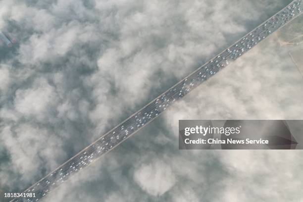 Aerial view of a bridge enveloped in thick fog on November 28, 2023 in Changsha, Hunan Province of China.